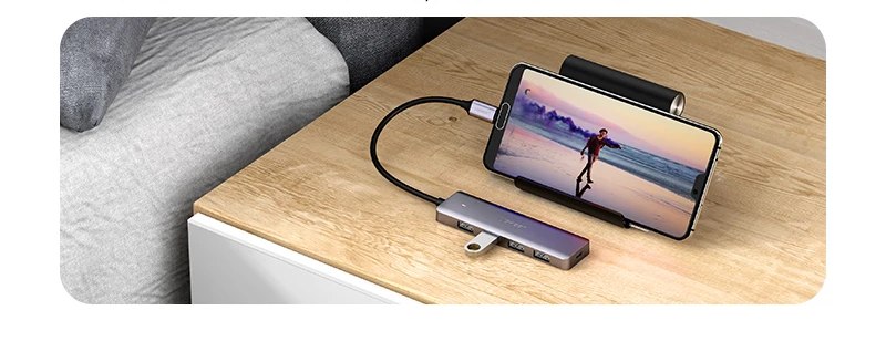 Android phone connected to a USB-C hub on a table